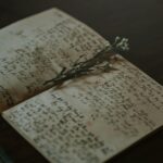 A vintage notebook with handwritten notes and delicate flowers, evoking nostalgia and warmth.