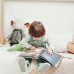 Adorable child reading a book in a cozy playroom, surrounded by toys. Perfect for early learning themes.