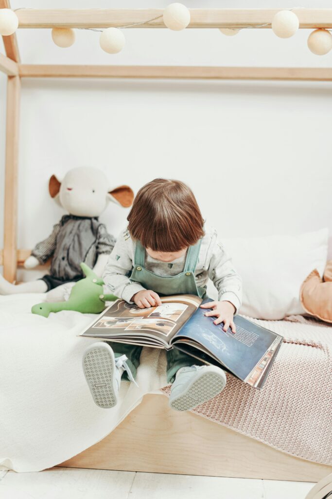 Adorable child reading a book in a cozy playroom, surrounded by toys. Perfect for early learning themes.