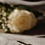 A vintage fountain pen with a rose bouquet on handwritten paper, evoking romantic elegance.