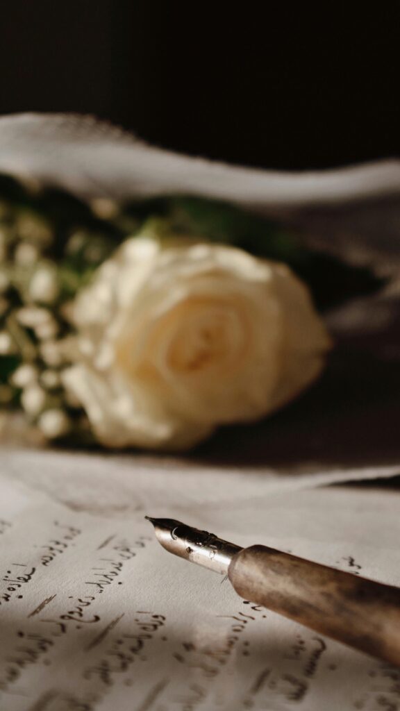 A vintage fountain pen with a rose bouquet on handwritten paper, evoking romantic elegance.