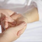Relaxing hand massage therapy session close-up with gentle touch and care.
