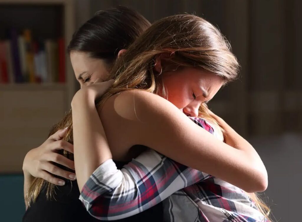 Mother and daughter hugging