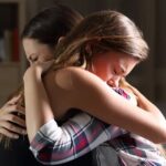 Mother and daughter hugging