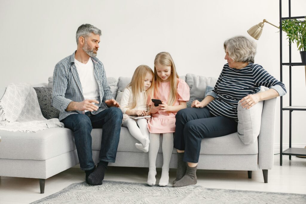 A joyful family enjoys quality time together on a cozy living room couch.