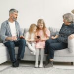 A joyful family enjoys quality time together on a cozy living room couch.