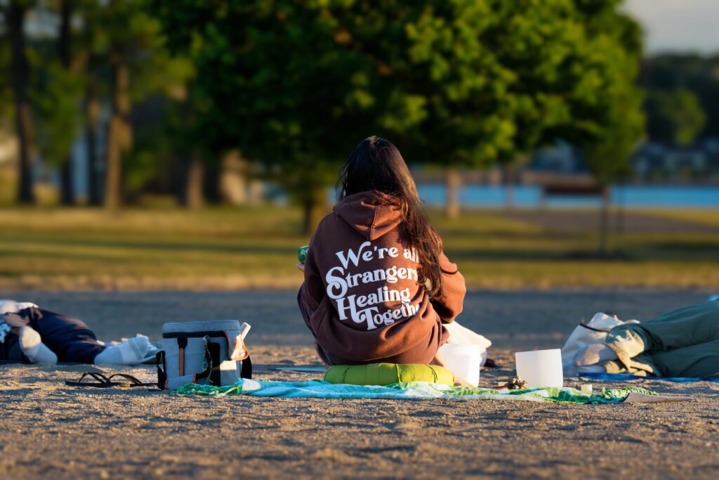 Person meditating outdoors at dawn in Cove Island Park, Stamford, Connecticut.